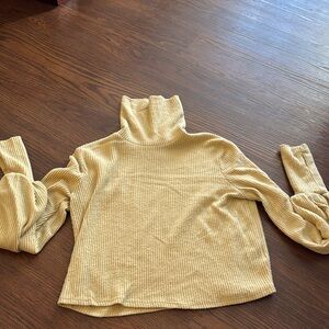 Out from under turtleneck with puffy sleeves